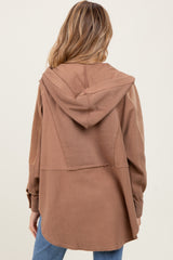 woman wearing a brown maternity hoodie with a relaxed fit and a hood, seen from the back