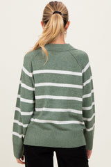woman wearing a green and white striped maternity sweater, view from the back