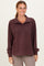 woman wearing a maroon pullover sweatshirt with a collar and button detail, featuring a front pocket