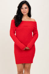 woman wearing a red off-the-shoulder sweater dress with a ribbed texture and long sleeves