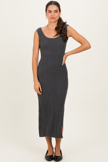 woman wearing a dark gray ribbed knit midi dress with a scoop neckline and side slits