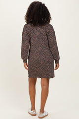 woman wearing a brown leopard print long sleeve dress from the back, with styled curly hair