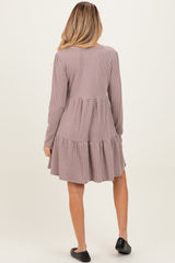 woman wearing a striped long sleeve maternity dress with a tiered skirt and ruched back design