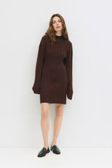 woman wearing a brown ribbed sweater dress with long sleeves and a fitted silhouette