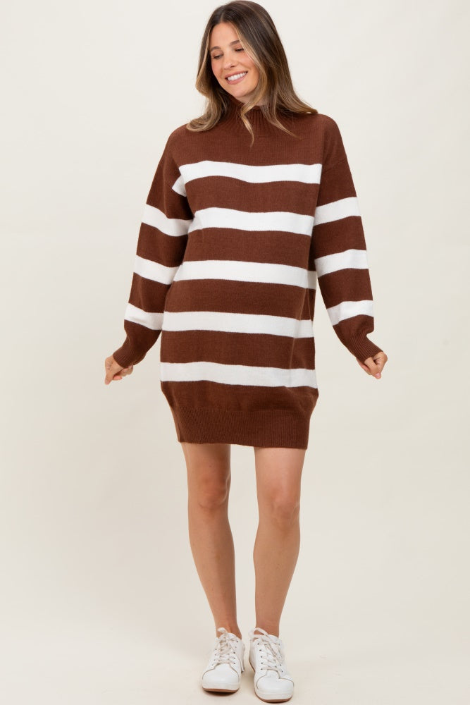 woman wearing a brown and white striped maternity sweater dress with long sleeves and a relaxed fit