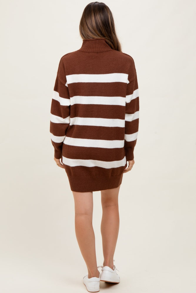 woman wearing a brown and white striped oversized sweater dress, showing a relaxed fit and a turtleneck, with no visible baby bump
