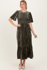 woman wearing a dark green velvet maxi dress with short sleeves and a tiered skirt