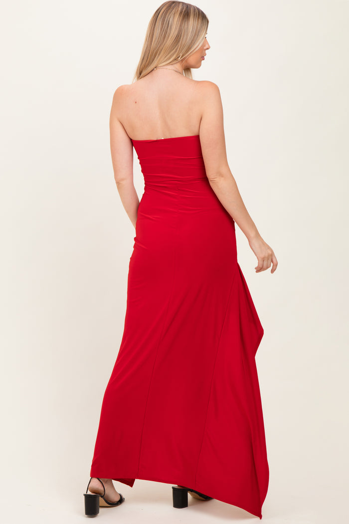 woman wearing a red strapless maxi dress with a fitted bodice and side slit, showing the back view
