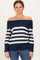 woman wearing a navy and white striped off-the-shoulder sweater paired with blue jeans