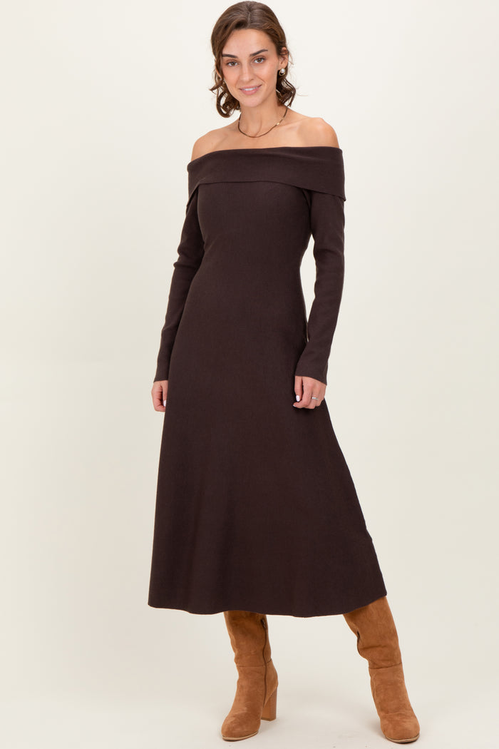 woman wearing a brown off-the-shoulder knit maxi dress and tan knee-high boots