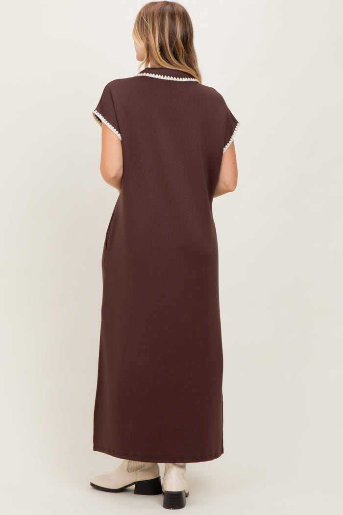 woman wearing a brown maxi dress with short sleeves and contrast detailing on the collar