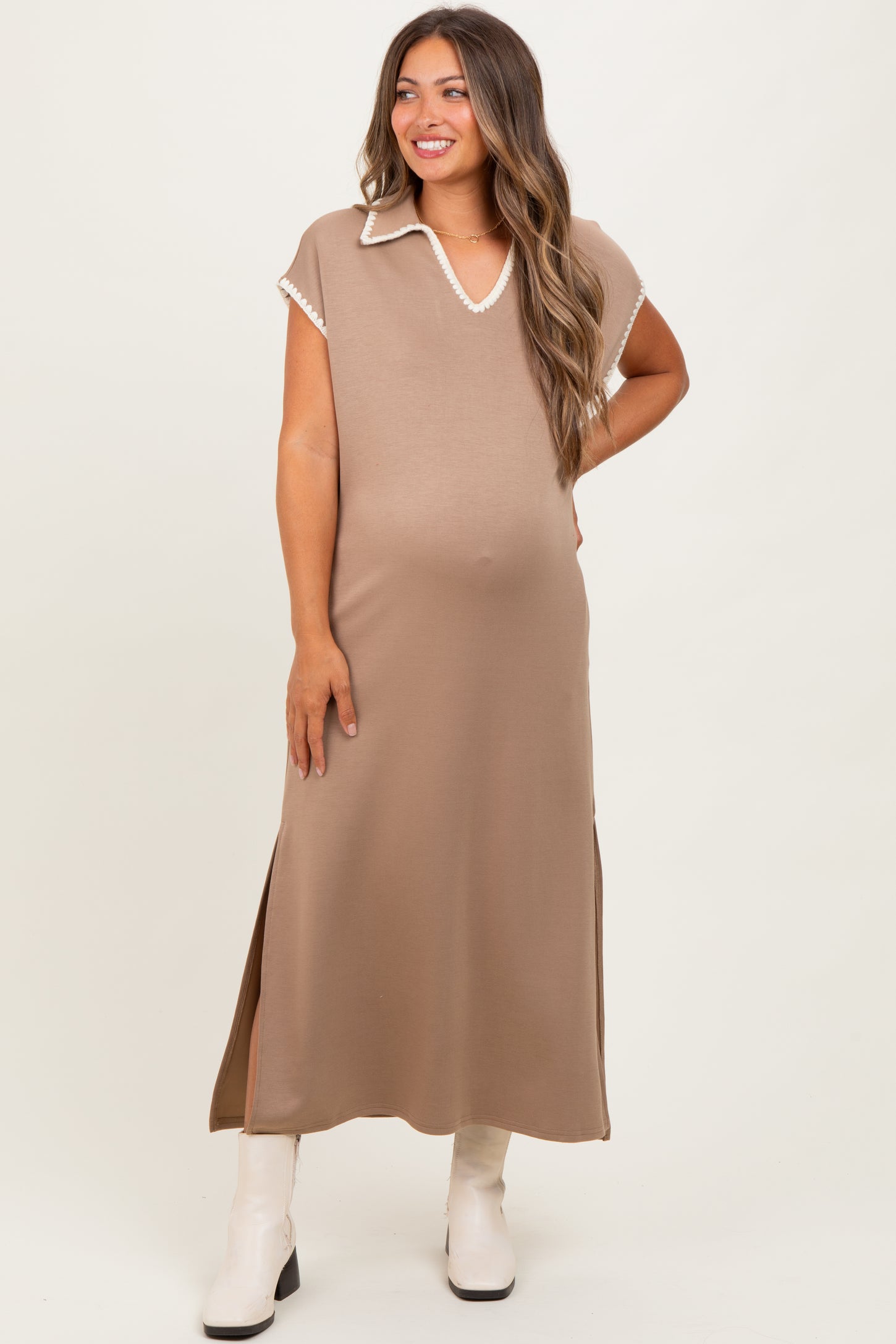 woman wearing a taupe maternity maxi dress with a v-neck and side slits, showing her baby bump