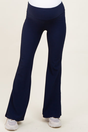 woman wearing navy blue maternity yoga pants with a flared leg and a high waistband