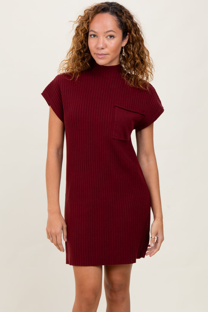 woman wearing a burgundy ribbed knit dress with a short sleeve and a front pocket