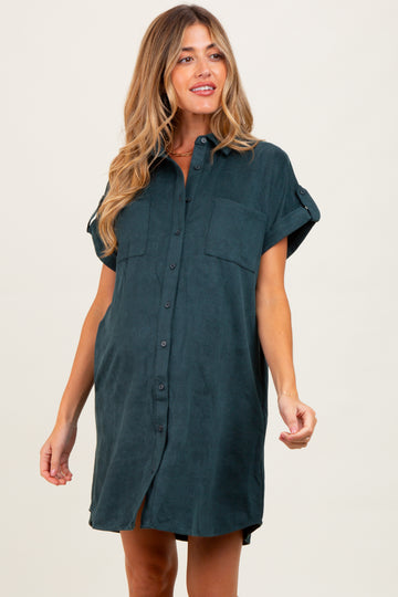 woman wearing a dark green short sleeve maternity shirt dress with two front pockets and buttons down the front