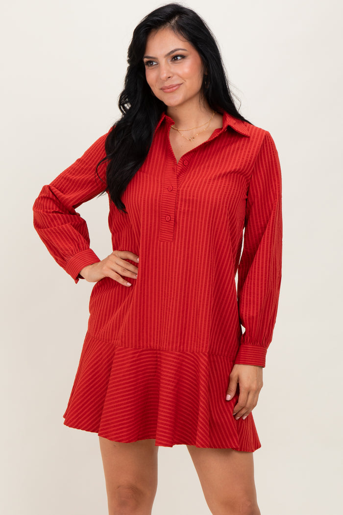 woman wearing a red striped long sleeve dress with a button-up collar and flared hemline
