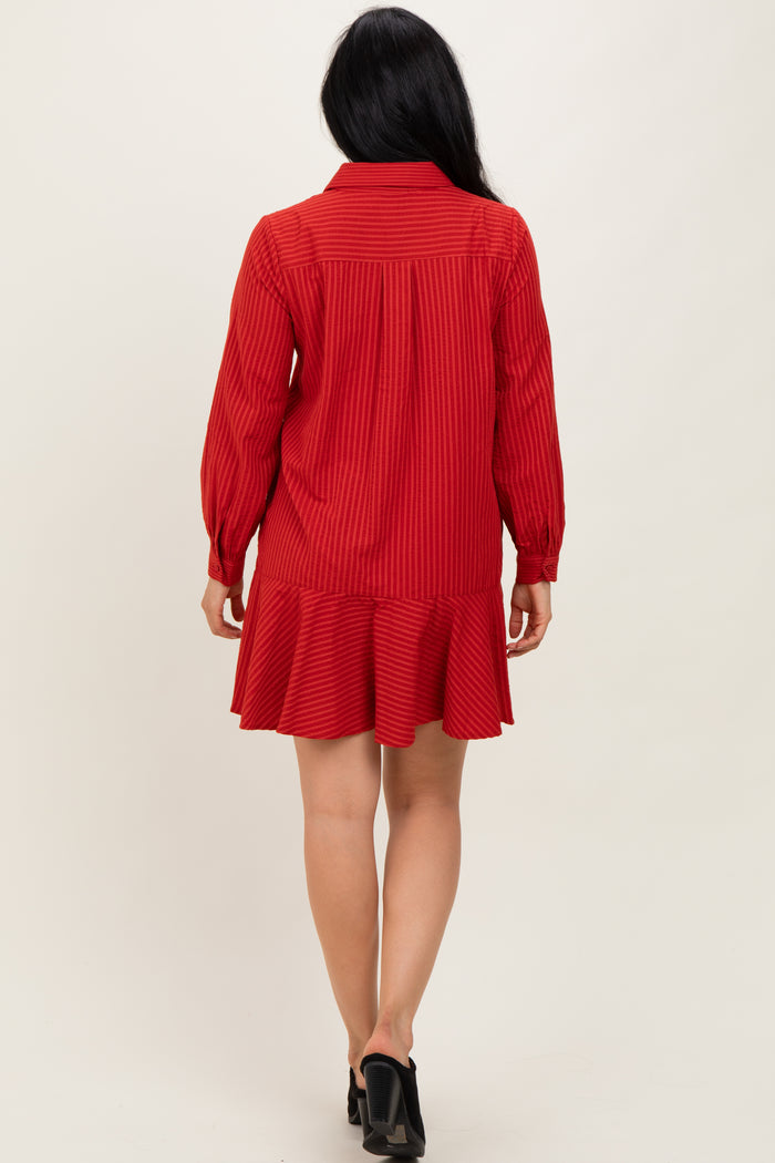woman wearing a red long-sleeve striped dress with a ruffled hem and a button-up collar, shown from the back