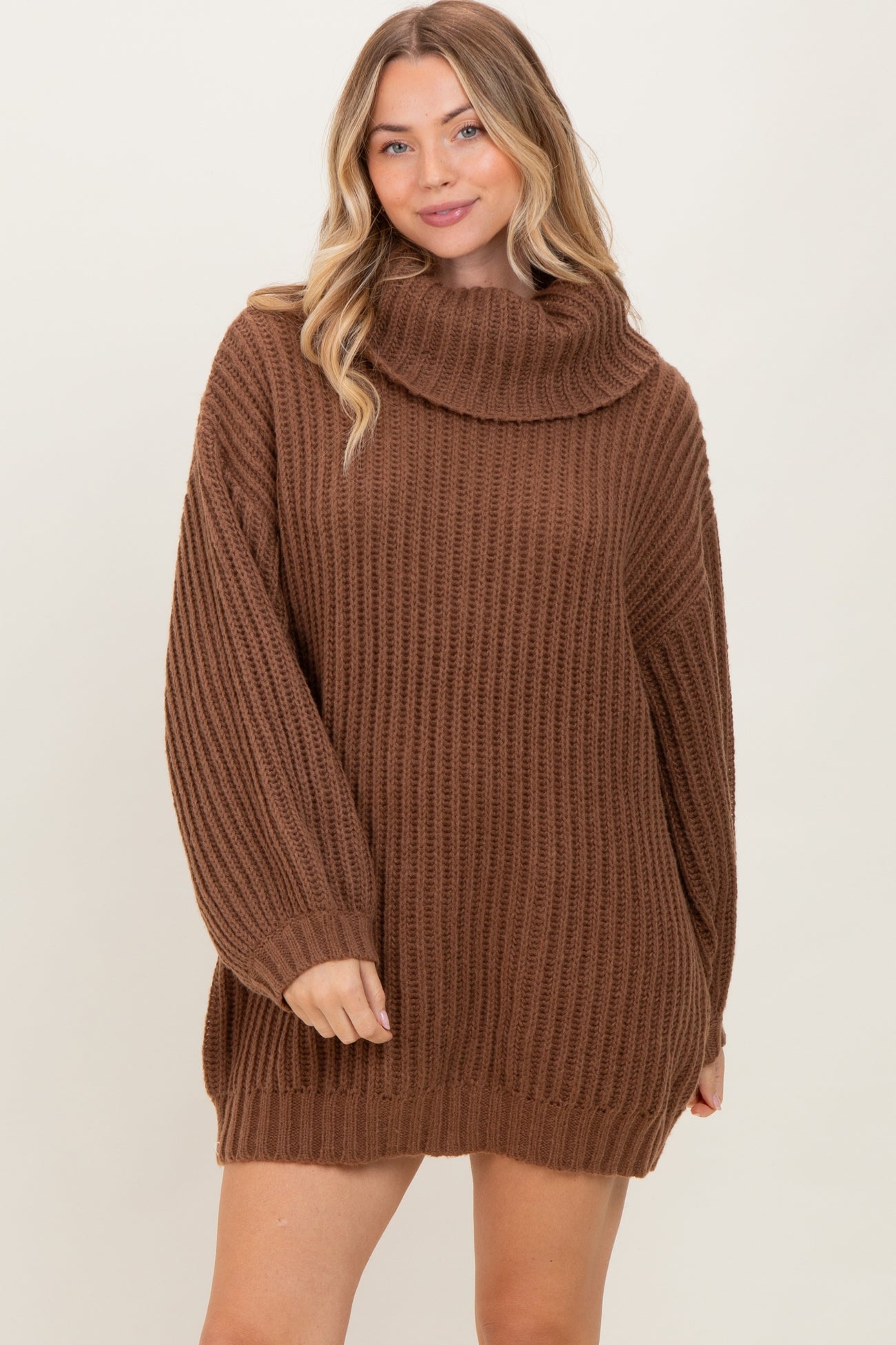 woman wearing a brown oversized cowl neck sweater dress with ribbed texture and long sleeves