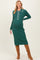 woman wearing a green ribbed maternity dress with a collared neckline and button details, showing her baby bump