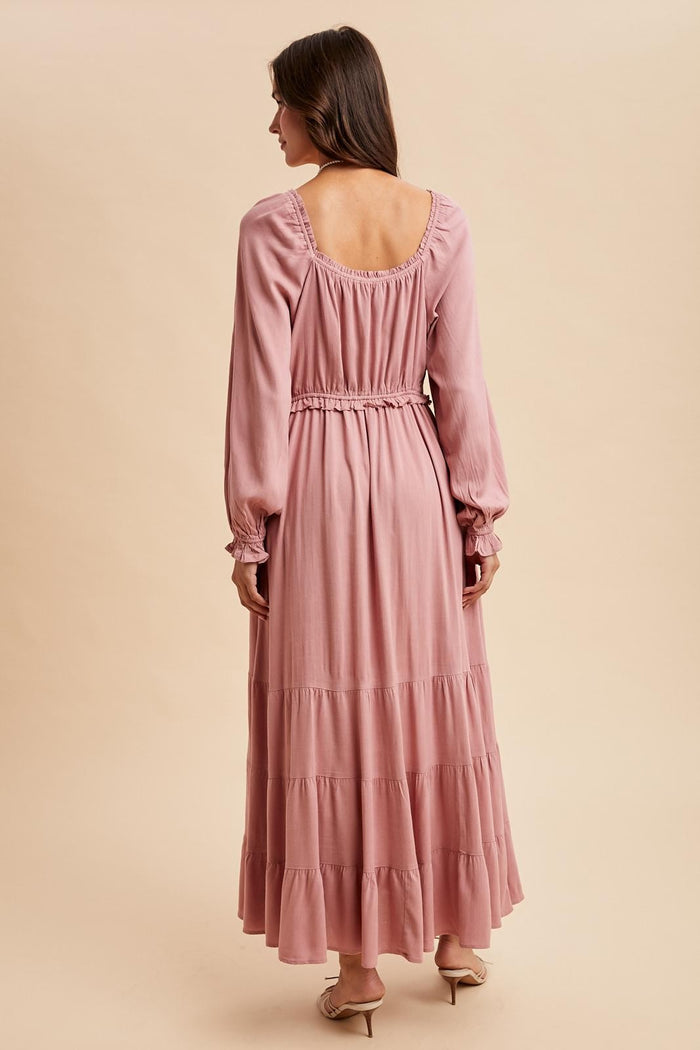 women's long sleeve dusty pink maxi dress with ruffled tiers and an elastic waist, shown from the back