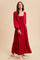 woman wearing a red long sleeve maxi dress with a drawstring neckline and tiered skirt