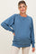 woman wearing a blue maternity sweatshirt with a relaxed fit and visible baby bump