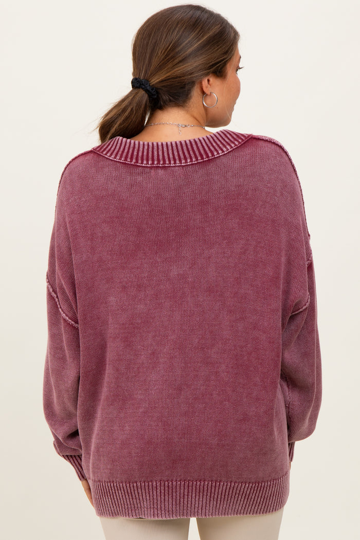 woman wearing a oversized purple maternity sweater, showing the back view with drop shoulders and a relaxed fit
