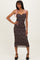 woman wearing a black and brown leopard print midi dress with pink tie straps and a fitted silhouette