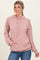 woman wearing a pink ribbed hooded sweatshirt with a front pocket and relaxed fit paired with blue jeans