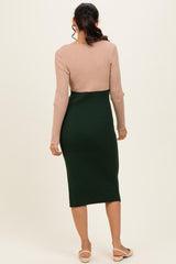 woman wearing a pink and green ribbed midi dress with a fitted silhouette and long sleeves, viewed from the back