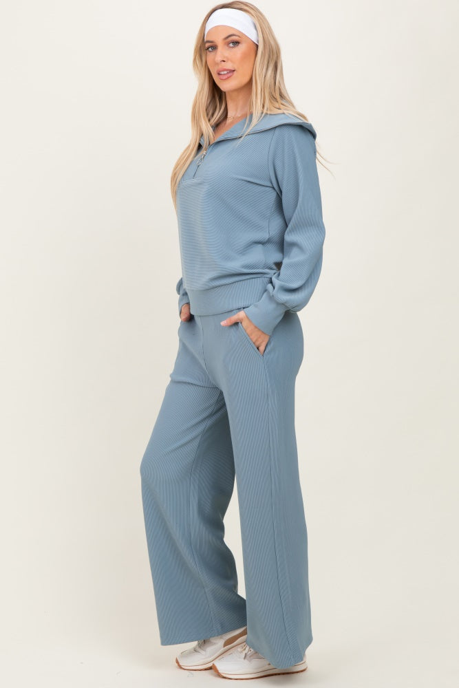 woman wearing a light blue ribbed hoodie and matching wide-leg pants with pockets
