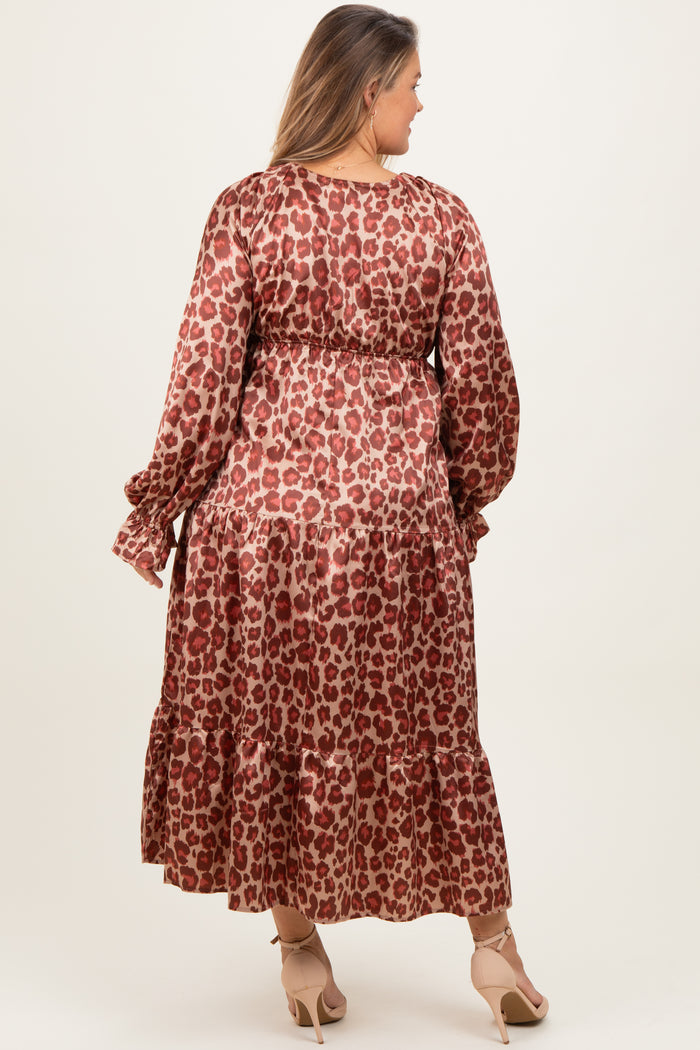 woman wearing a brown leopard print maternity dress with long sleeves and tiered skirt, showcasing her baby bump from the back