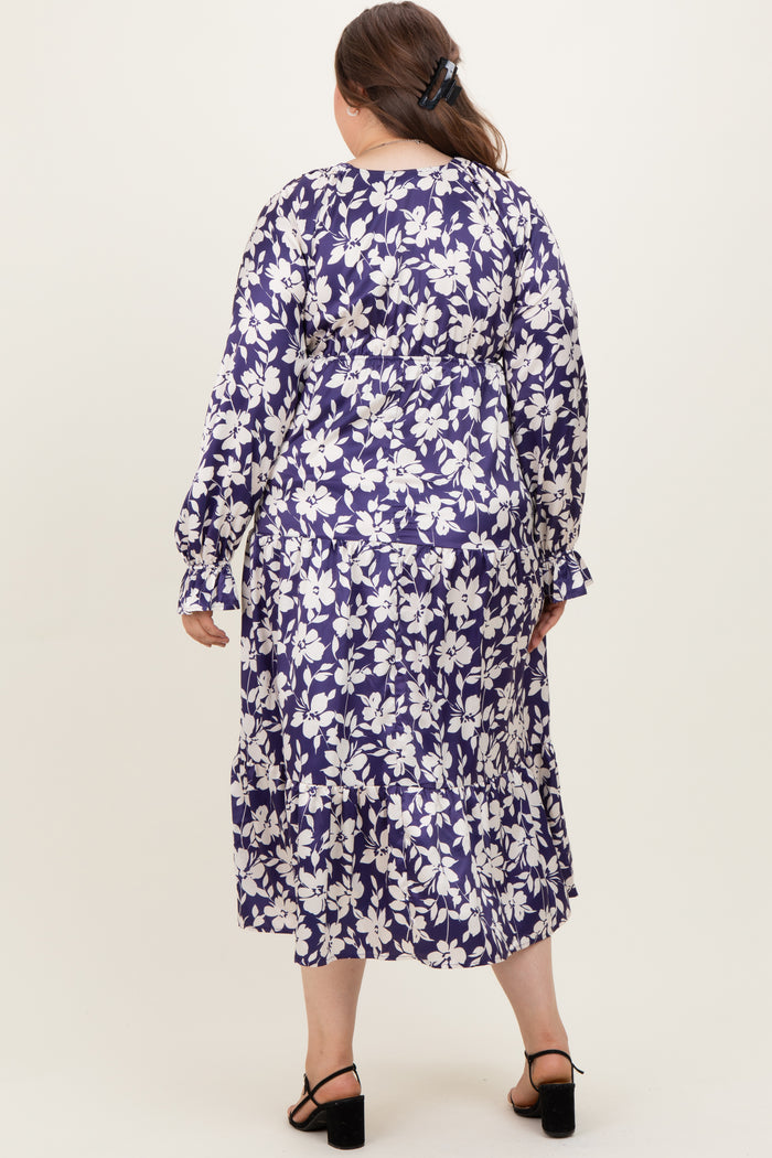 woman wearing a floral print long sleeve maternity plus dress with a tiered skirt, showing the back view