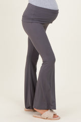 woman wearing dark gray maternity yoga pants with a flared leg and a visible baby bump