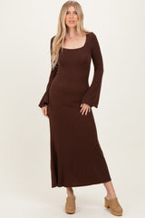 woman wearing a brown long sleeve ribbed maxi dress with a square neckline and flared sleeves