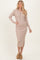 woman wearing a beige ribbed knit midi dress with a collar, button front, and side slit, paired with brown clogs