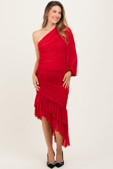 woman wearing a red one-shoulder maternity dress with ruched detailing and asymmetrical hem