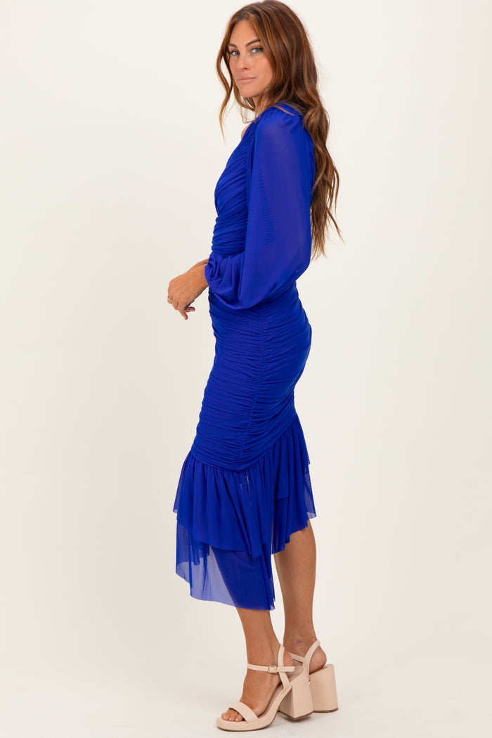 woman wearing a fitted royal blue dress with ruched detailing and a layered chiffon hem