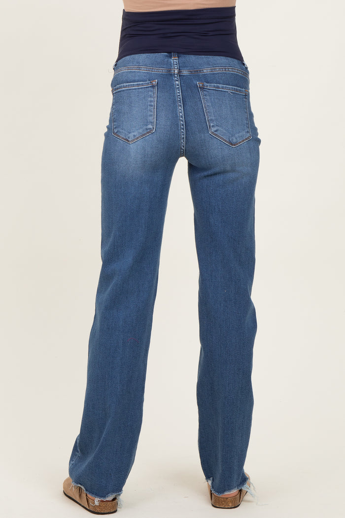 woman wearing blue maternity jeans with a supportive waistband and a straight leg fit, viewed from the back