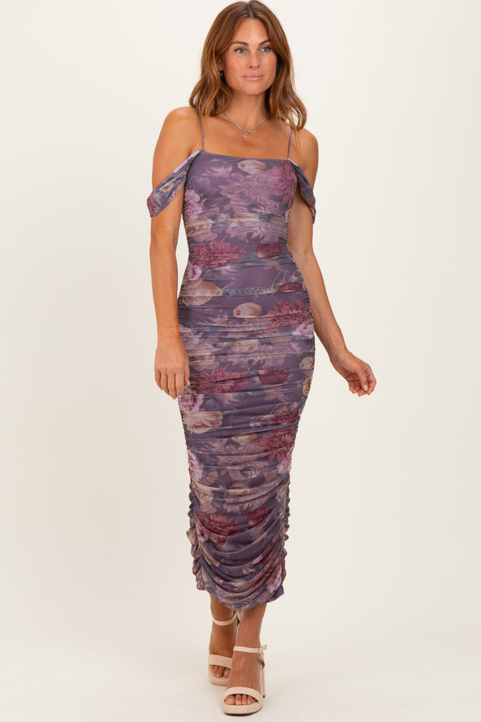 woman wearing a purple floral off-shoulder midi dress with ruching and a bodycon fit