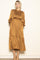 woman wearing a mustard yellow long sleeve smocked maxi dress with a tiered skirt and a relaxed fit