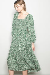 woman wearing a green floral long sleeve midi dress with a square neckline and relaxed fit