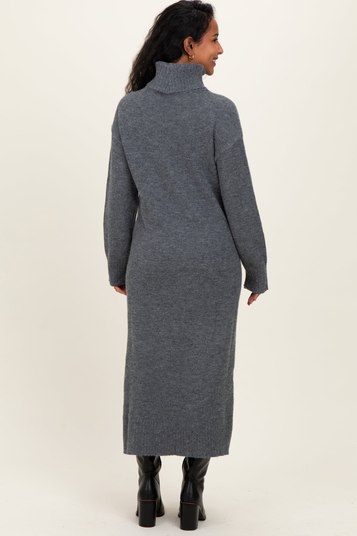 woman wearing a gray long sleeve turtleneck maternity dress, showing a relaxed fit and ankle length