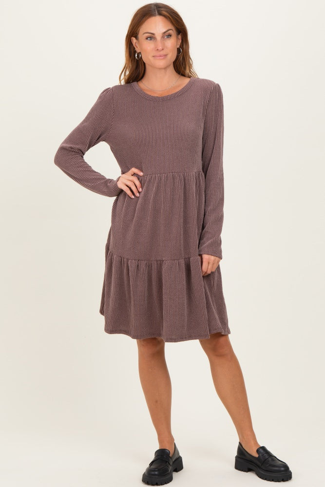 woman wearing a dusty rose long sleeve striped dress with a tiered skirt and a round neckline