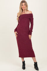 woman wearing a burgundy off-the-shoulder long sleeve dress with fitted silhouette and ribbed fabric