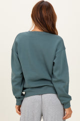 woman wearing a soft green oversized sweatshirt with a relaxed fit, shown from the back