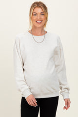 woman wearing a light gray maternity sweatshirt with a relaxed fit and a visible baby bump