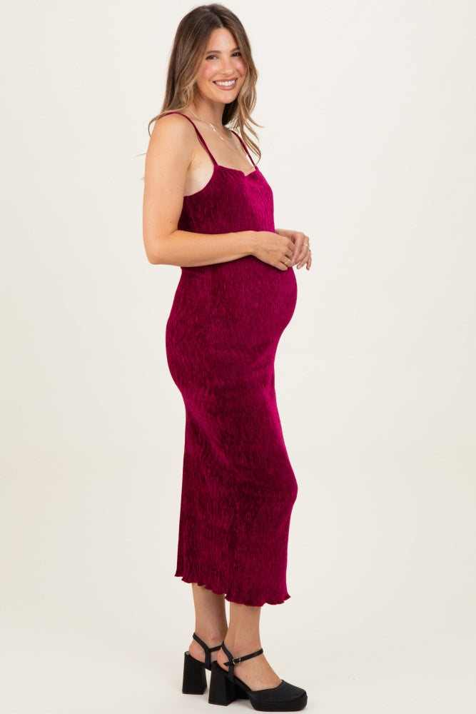woman wearing a fuchsia maternity slip dress with spaghetti straps and a visible baby bump