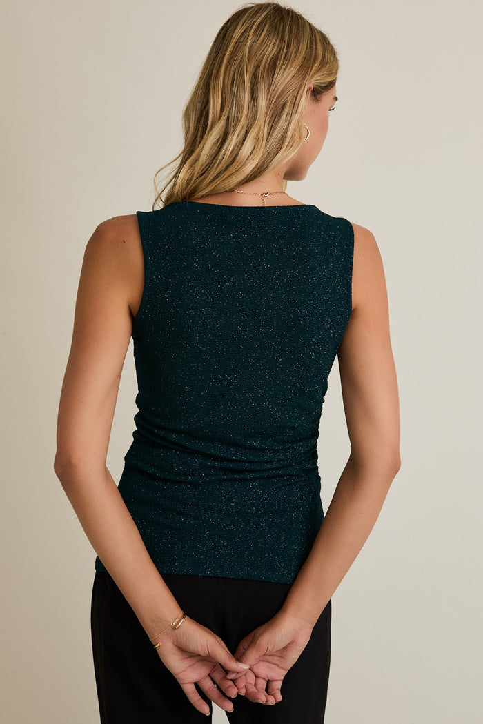 woman wearing a teal sleeveless top with a ruched back and subtle glitter details