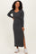 woman wearing a dark gray long sleeve ribbed maxi dress with side slits and sneakers